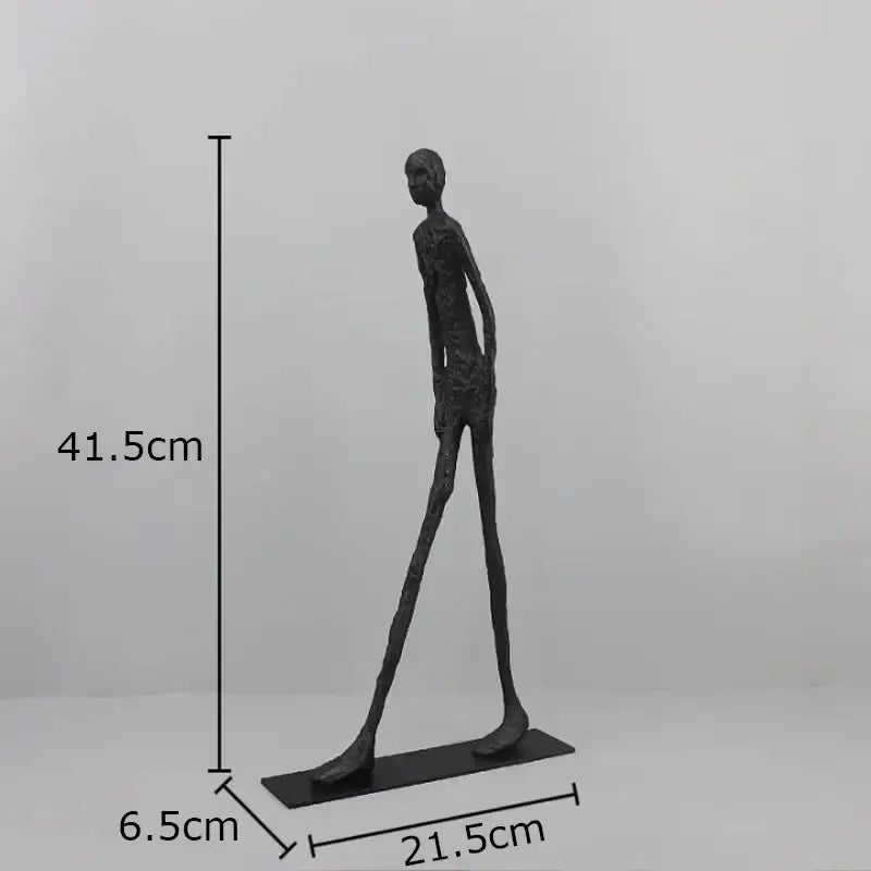 Decorbites abstract cast iron acrobatics sculpture is a black matte human figure with elongated limbs on a rectangular base