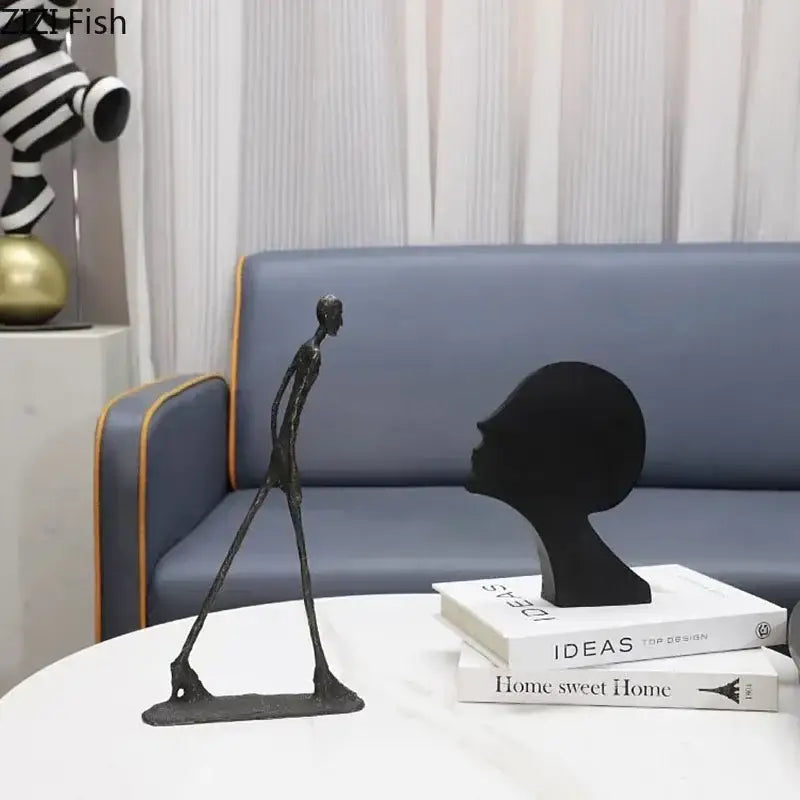 Decorbites abstract cast iron sculpture features slender black matte acrobatics figures for desk decoration