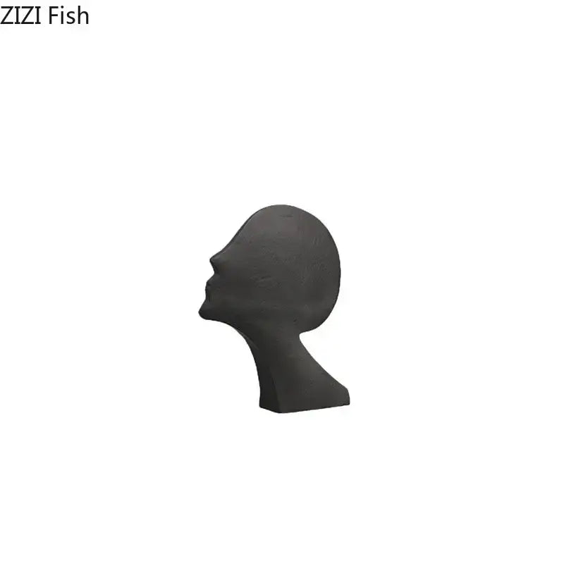 Dark gray ceramic sculpture of a human head in profile complementing decorbites abstract cast iron acrobatics figures