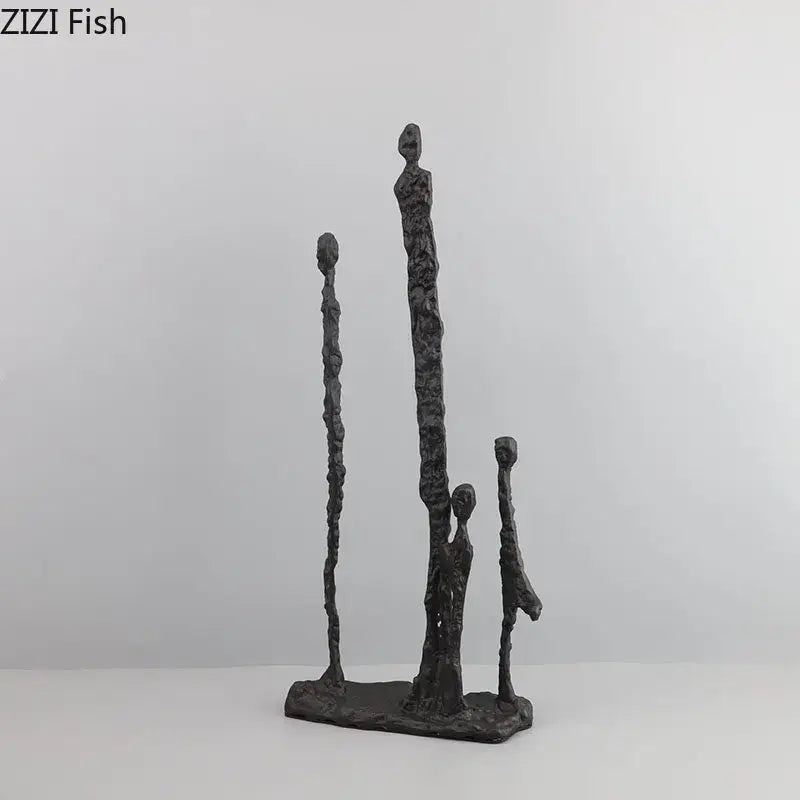 Dark gray textured abstract cast iron figure sculpture of four stylized human forms on rectangular base decorbites abstract cast