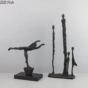Decorbites abstract cast iron figure sculpture in black matte finish depicting a dancer in mid-leap pose on base
