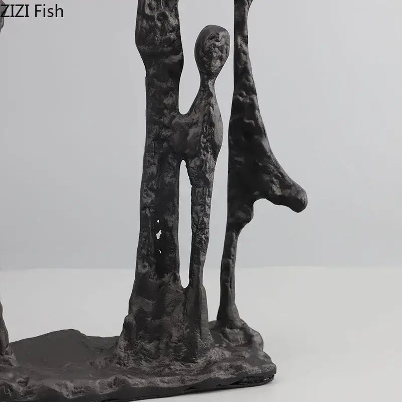Decorbites abstract cast iron black metal figure sculpture with three elongated humanoid figures on shared base