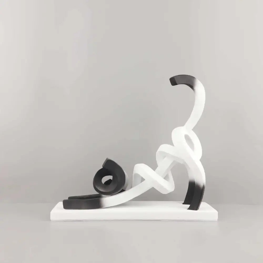 Decorbites abstract cat sculpture is a black and white resin piece with flowing intertwined forms for children’s decor