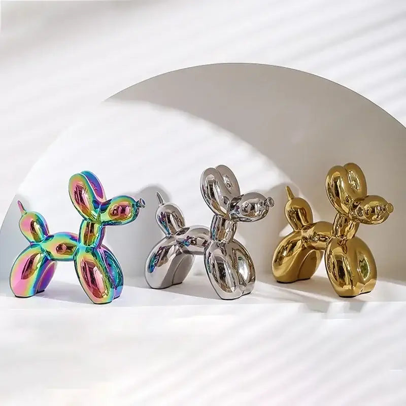 Three glossy balloon dog figurines in iridescent silver and gold finishes by DecorBites abstract ceramic balloon decor