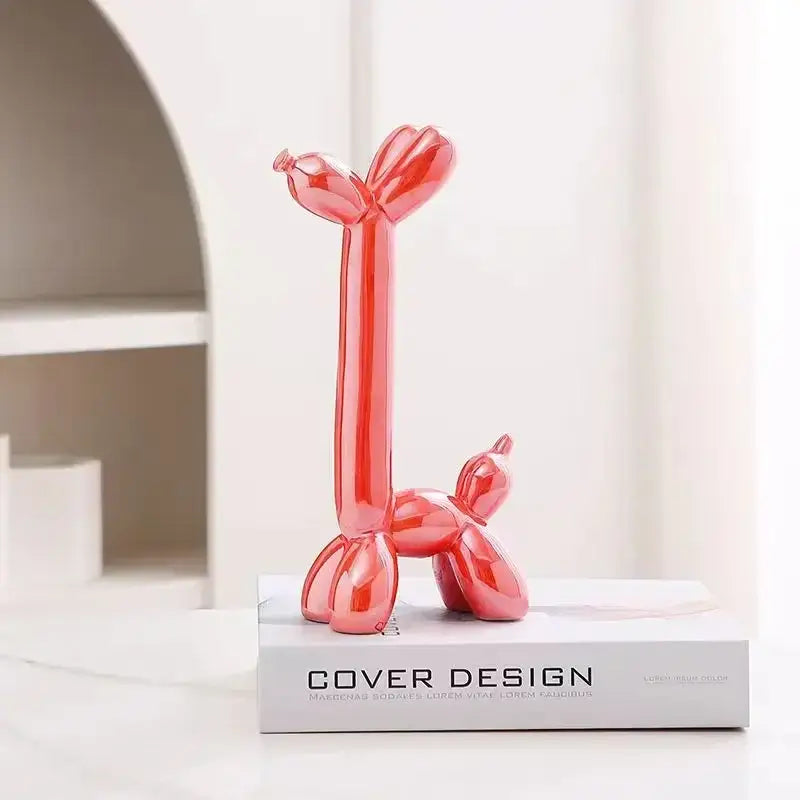 Glossy red decorbites abstract ceramic balloon dog sculpture with sleek elongated body for home office décor