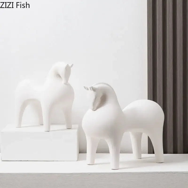 Two minimalist white glossy decorative figurines of abstract ceramic horse sculptures by DecorBites™