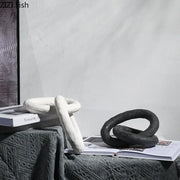 DecorBites abstract ceramic knot sculpture in white and black with a matte textured finish for room aesthetic decor
