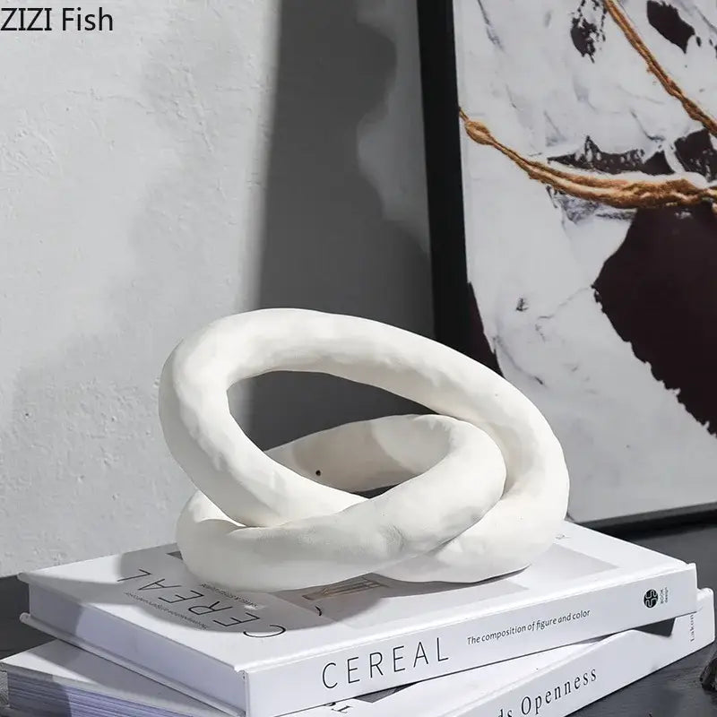 White ceramic abstract ceramic knot sculpture with intertwined loops by DecorBites for room aesthetic decor