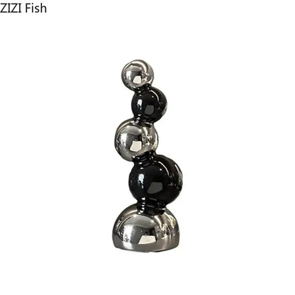 Decorbites abstract ceramic sculpture ornaments featuring sleek black and silver glossy spheres for modern desk decor