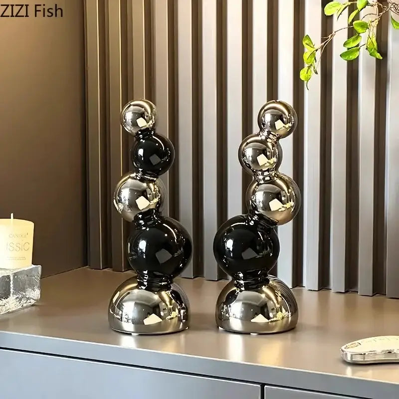 Two sleek black and chrome decorbites abstract ceramic sculpture ornaments with glossy finish for modern desk decoration