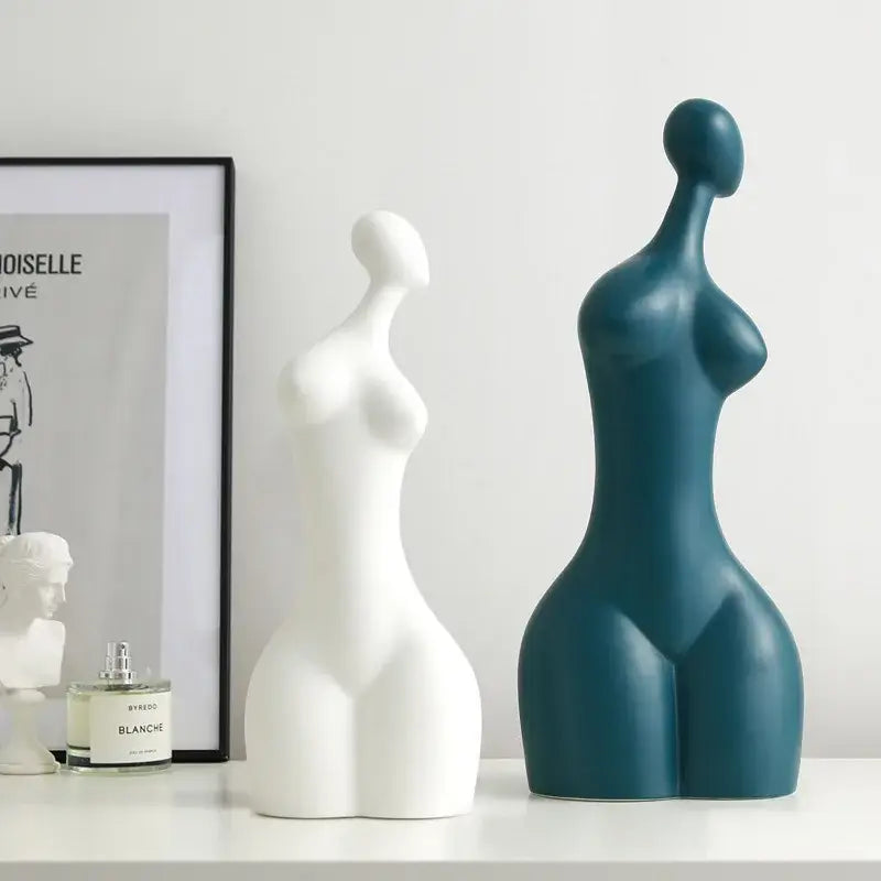 Two decorbites abstract ceramic sexy woman statues in white and teal blue with smooth glossy surfaces