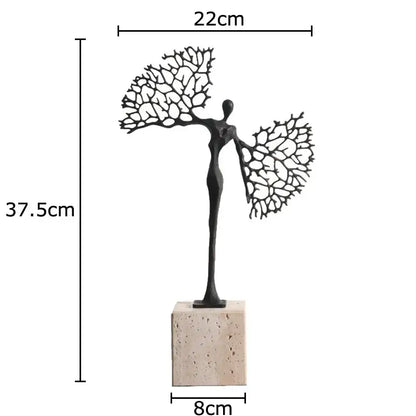 Black metal abstract character marble sculpture with branching arms on beige stone base for marble sculpture room decor