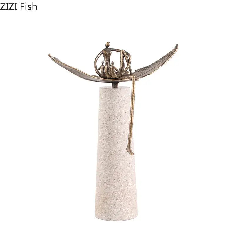 Bronze-colored abstract character marble sculpture featuring an angel and seated figure on an off-white pedestal for room decor
