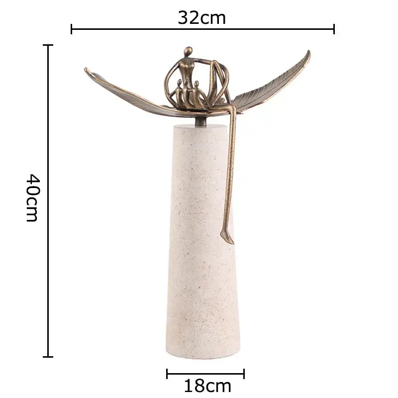 Bronze-colored abstract character marble sculpture with outstretched wings on textured off-white base for room decor