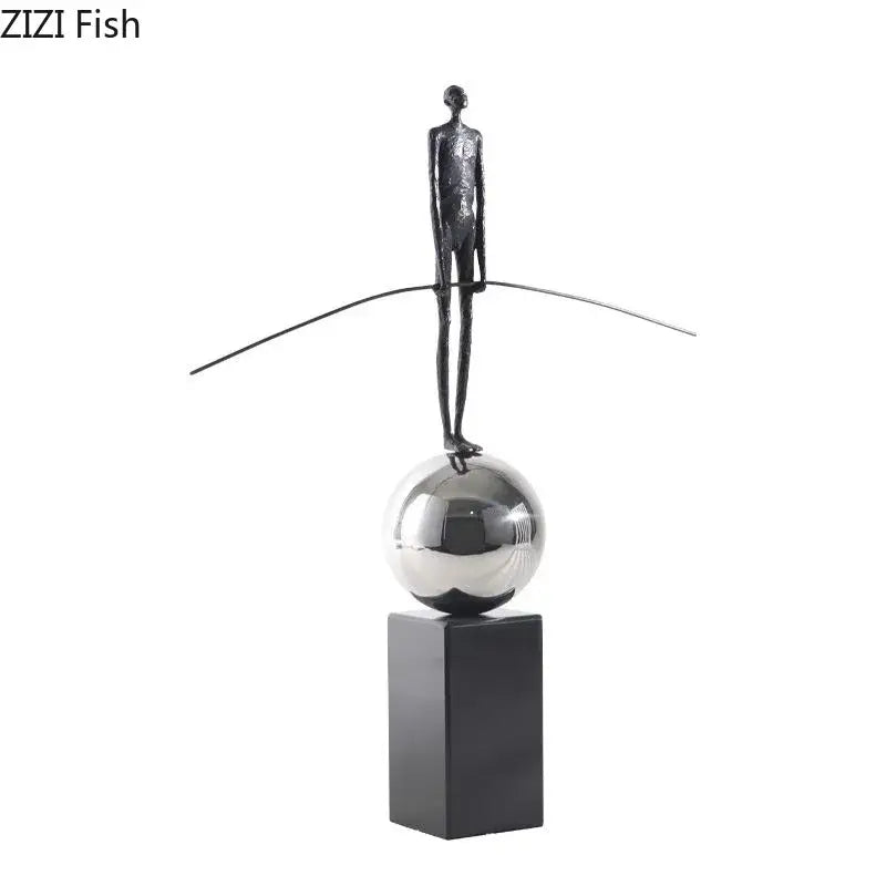 A sleek DecorBites™ abstract character marble sculpture with a black figure balancing on a silver sphere for room decor