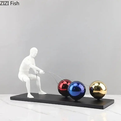 White resin decorbites abstract character metal sculpture of man pulling three colorful metallic spheres on strings desk ornament