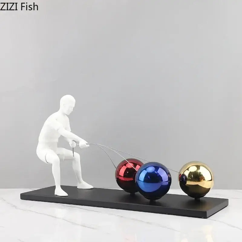 White resin decorbites abstract character metal sculpture of man pulling three colorful metallic spheres on strings desk ornament