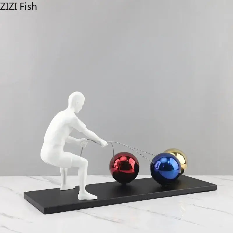 White resin decorbites abstract character figurine pulling red blue and gold spheres in metal sculpture desk ornament