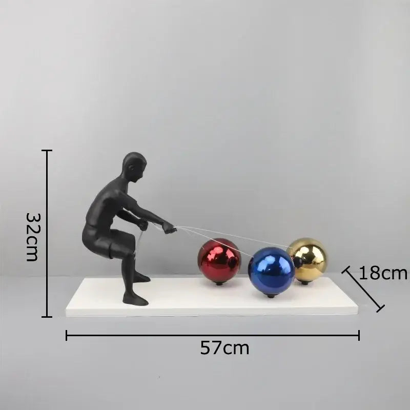Black metal sculpture figurine pulling red blue and gold glossy spheres decorbites abstract character desk ornament