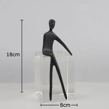 DecorBites abstract character sculpture featuring a black figurine with elongated limbs on a crystal base for modern decor