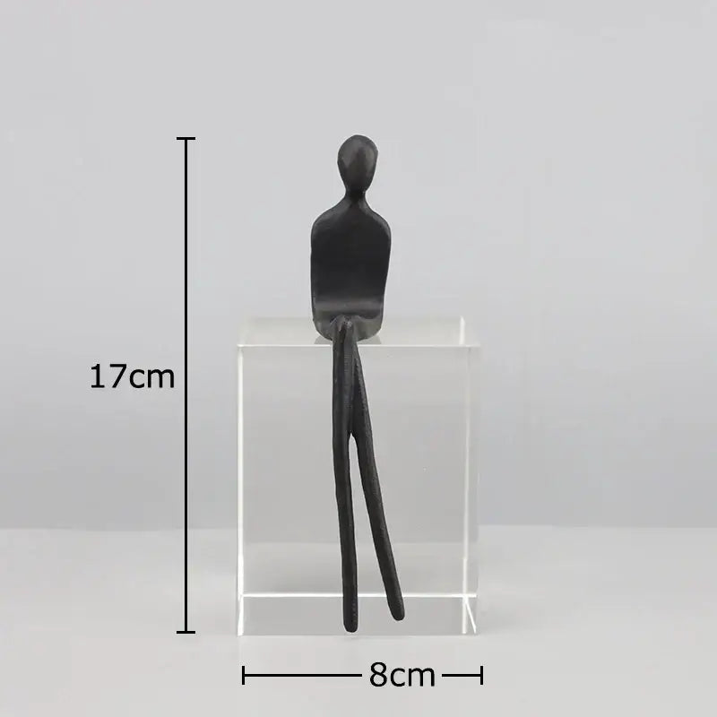 Black matte finished decorbites abstract character sculpture seated on crystal base for modern room decor