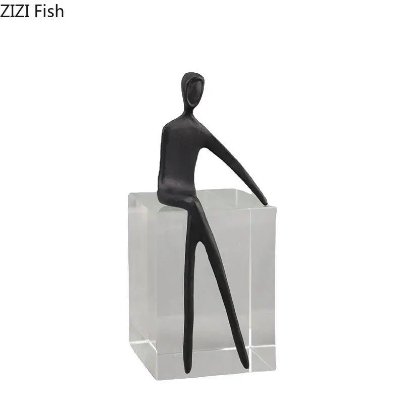 Black decorbites abstract character sculpture with elongated limbs resting on a crystal base for modern room decor