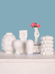 White ceramic vases with sculpted lips fist and faces from decorbites abstract character white ceramics for modern decor