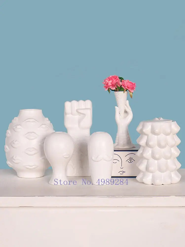White ceramic vases with sculpted lips raised fist and stylized faces decorbites abstract character modern home decor