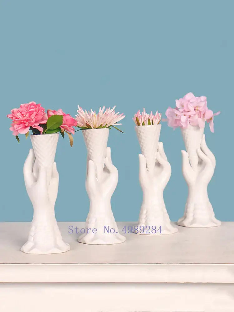 Decorbites abstract character white ceramics vase with hand-shaped textured fingers holding pink and purple flowers