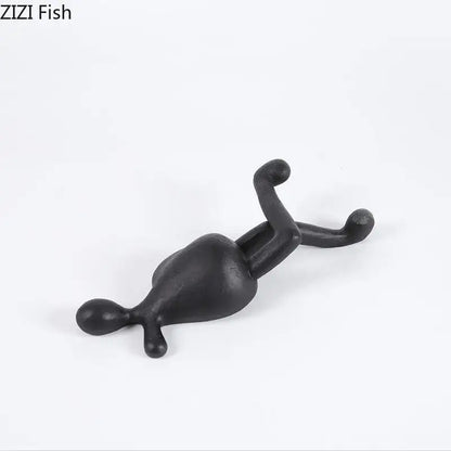 Black matte-finished decorbites abstract characters resin sculpture with elongated limbs for modern home decor