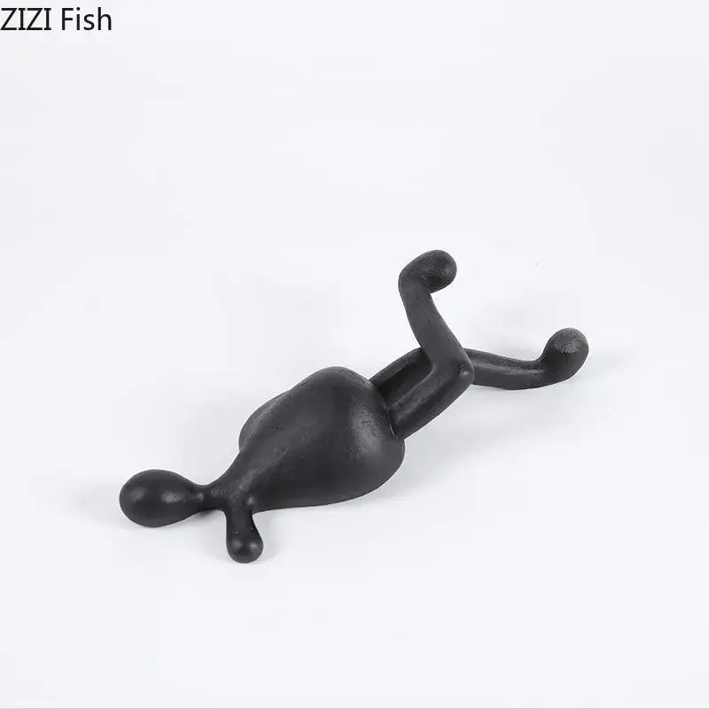 Black matte-finished decorbites abstract characters resin sculpture with elongated limbs for modern home decor