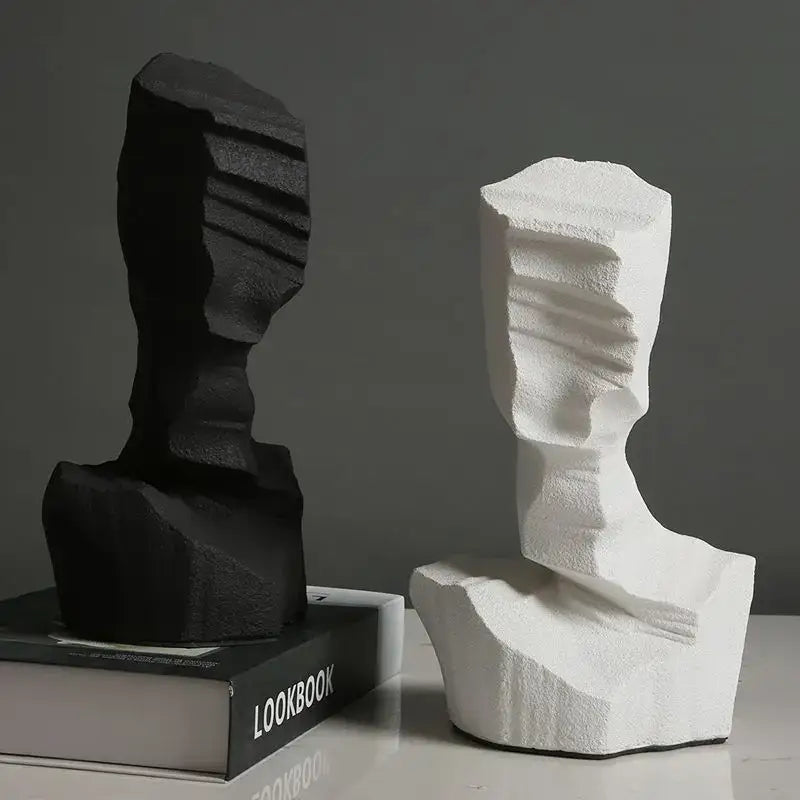 Black and white abstract characters sculpture bookends with textured layered surfaces for modern living room decor by decorbites