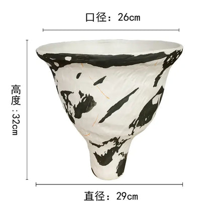 White ceramic decorbites abstract clay pot with bold black brushstroke patterns and a textured handcrafted surface