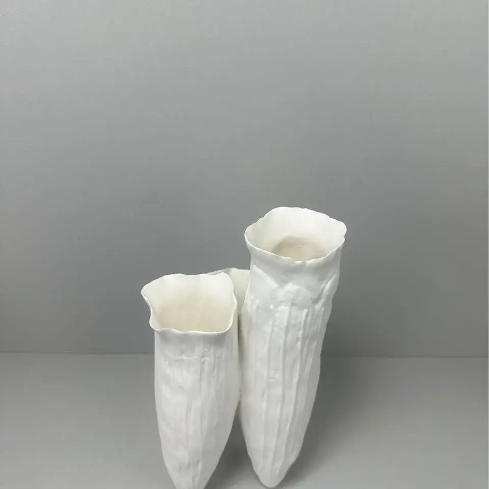 Two white ceramic vases with textured ribbed surfaces and flared rims for decorbites abstract coral reef home decor
