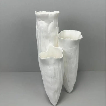 Three white ceramic DecorBites abstract coral reef vases with textured flared rims for home decor display