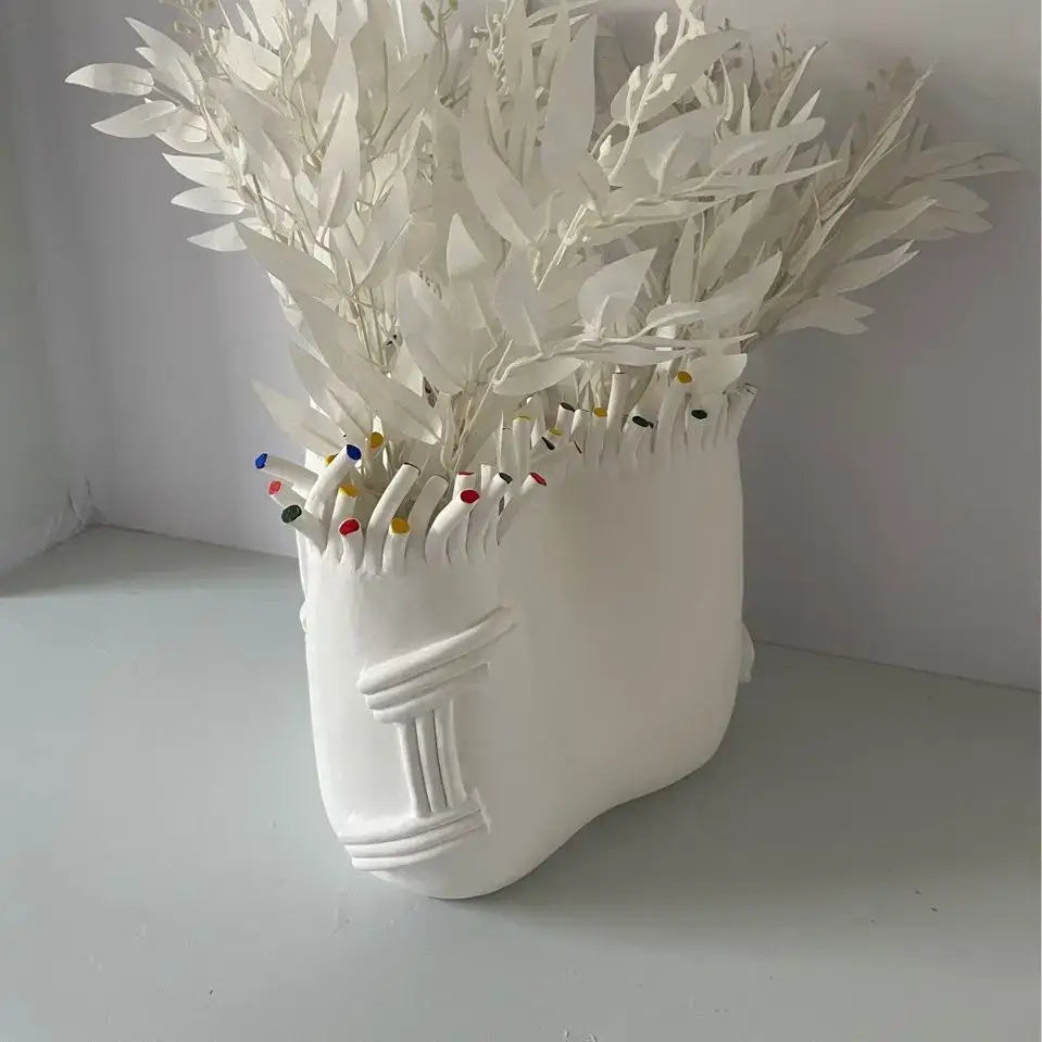 Decorbites abstract coral ceramic vase shaped like a white stylized human face with coral shapes flower decoration