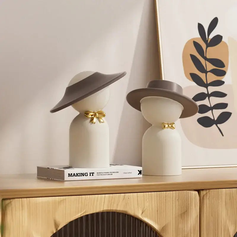Two minimalist white ceramic decorbites abstract couple bust figurines with brown hats and gold bow ties for home decor