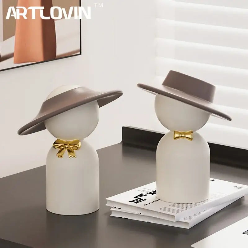 White ceramic decorbites abstract couple bust sculpture with gray hats and gold bow ties for stylish home decor