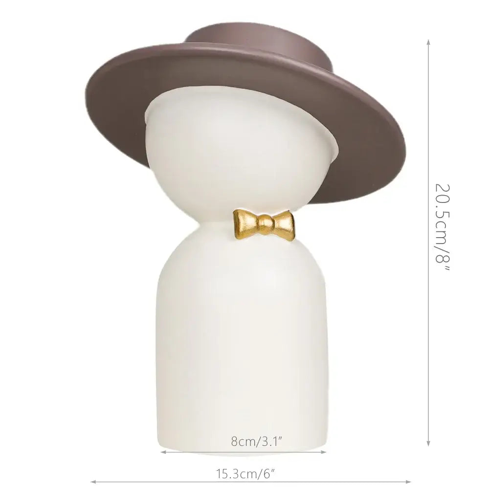 A sleek white ceramic decorbites abstract couple bust sculpture featuring a man with a brown top hat and gold bow tie