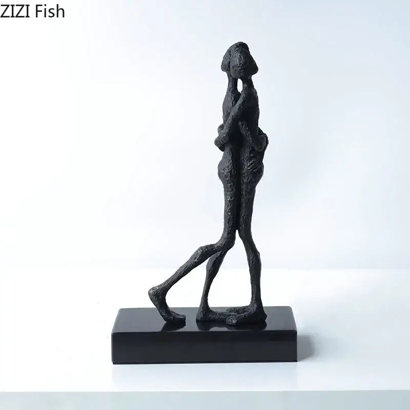 Black abstract couple statue by decorbites featuring two figures in an embrace on a sleek base for decoration