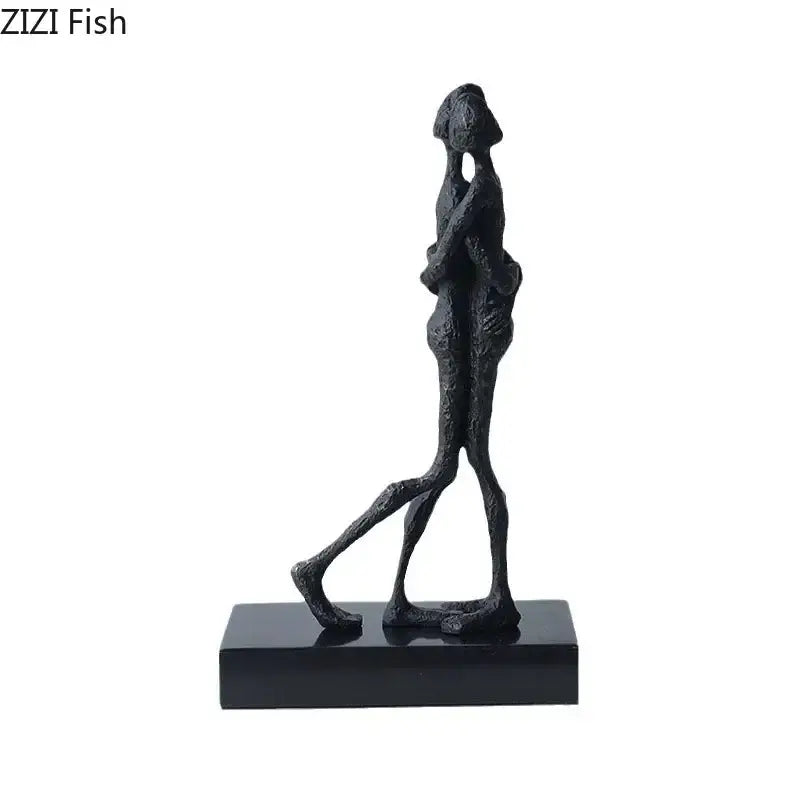 Black abstract couple statue by DecorBites featuring two figures in an embrace on a matching black base for decor