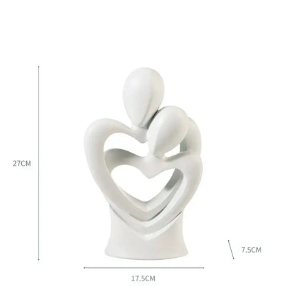 White ceramic decorbites abstract dancer resin sculpture featuring two abstract dancer figures embracing in heart frame