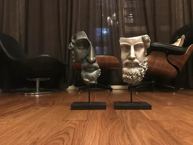 Two decorbites abstract david face resin sculptures featuring bearded classical busts in dark metallic and off-white finishes