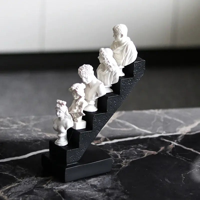 White marble busts of classical figures in a staircase design on a black base for decorbites abstract david home decor