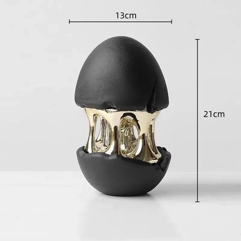 Black and gold ceramic decorative figurine of a cracked egg with abstract eggshell hollow intricate skeletal interior by DecorBites