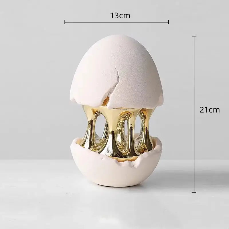 White ceramic decorative figurine featuring a gold molten interior in the decorbites abstract eggshell hollow design