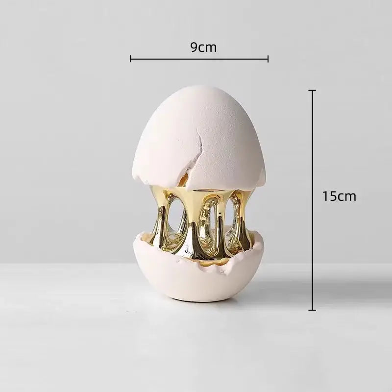 A white ceramic decorative figurine with a gold metallic interior and cracked shell design by DecorBites abstract eggshell hollow