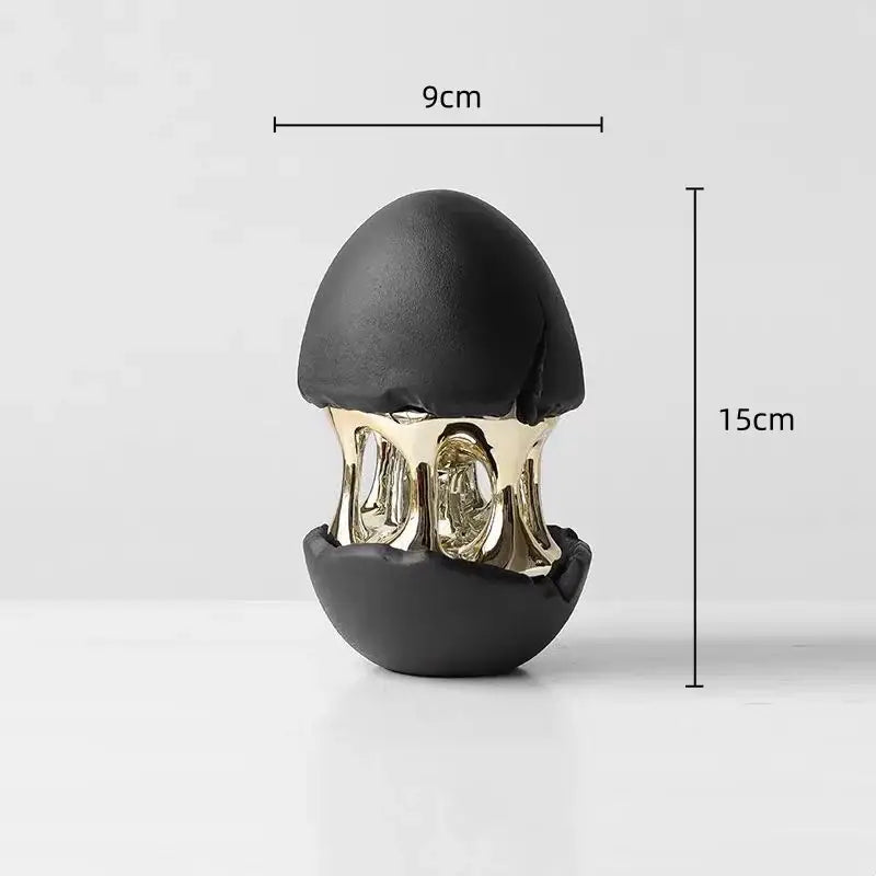 Black and gold decorative figurine featuring decorbites abstract eggshell hollow with cracked top and metallic interior