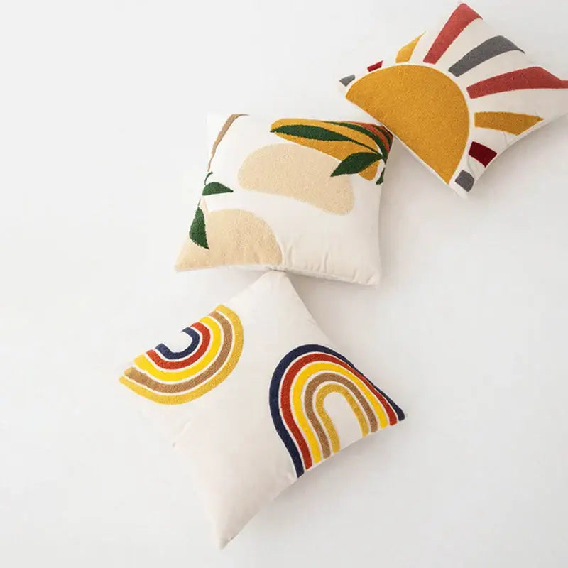 White square velvet cushion cover with colorful abstract embroidery of suns rainbows and leaves by decorbites abstract embroidery