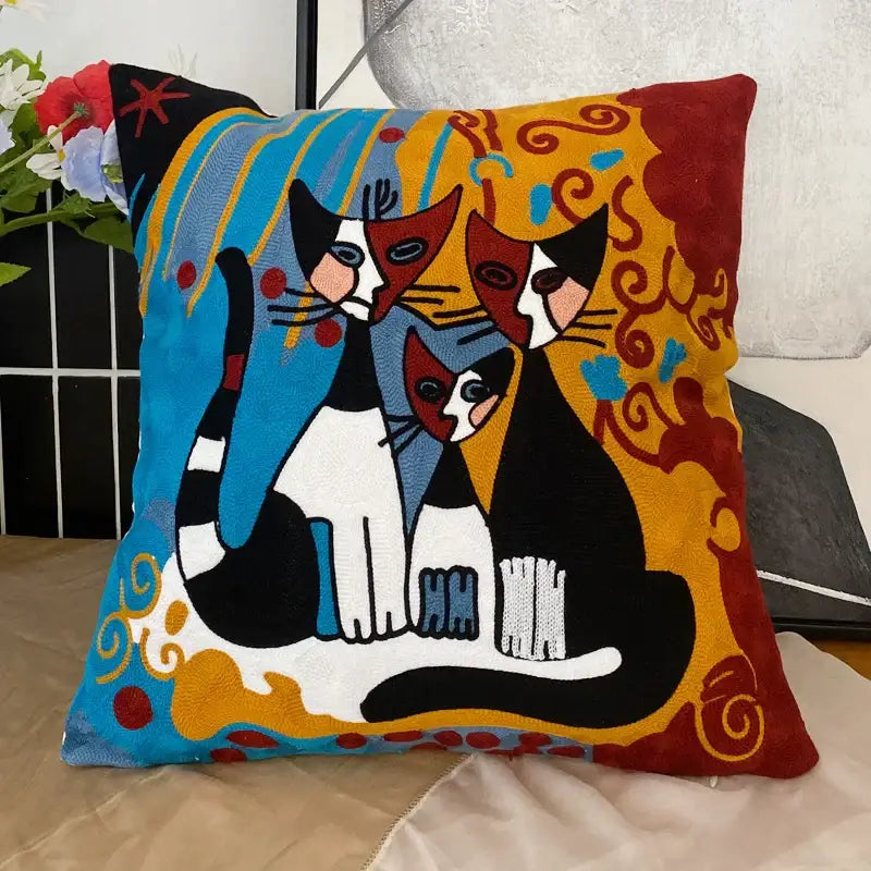 Vibrant decorbites abstract embroidery pillowcase featuring stylized black and white cats on colorful blue yellow red background